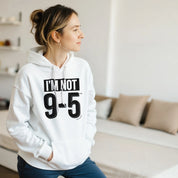 Person wearing a white hoodie with text in a living room