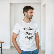 Man wearing a white t-shirt with 'Partner Over Profit' text in a minimal indoor setting