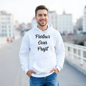 Man wearing a white hoodie with 'Partner Over Profit' text, standing on a bridge.