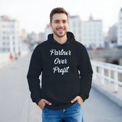 Man wearing a black hoodie with 'Partner Over Profit' text, standing outdoors.