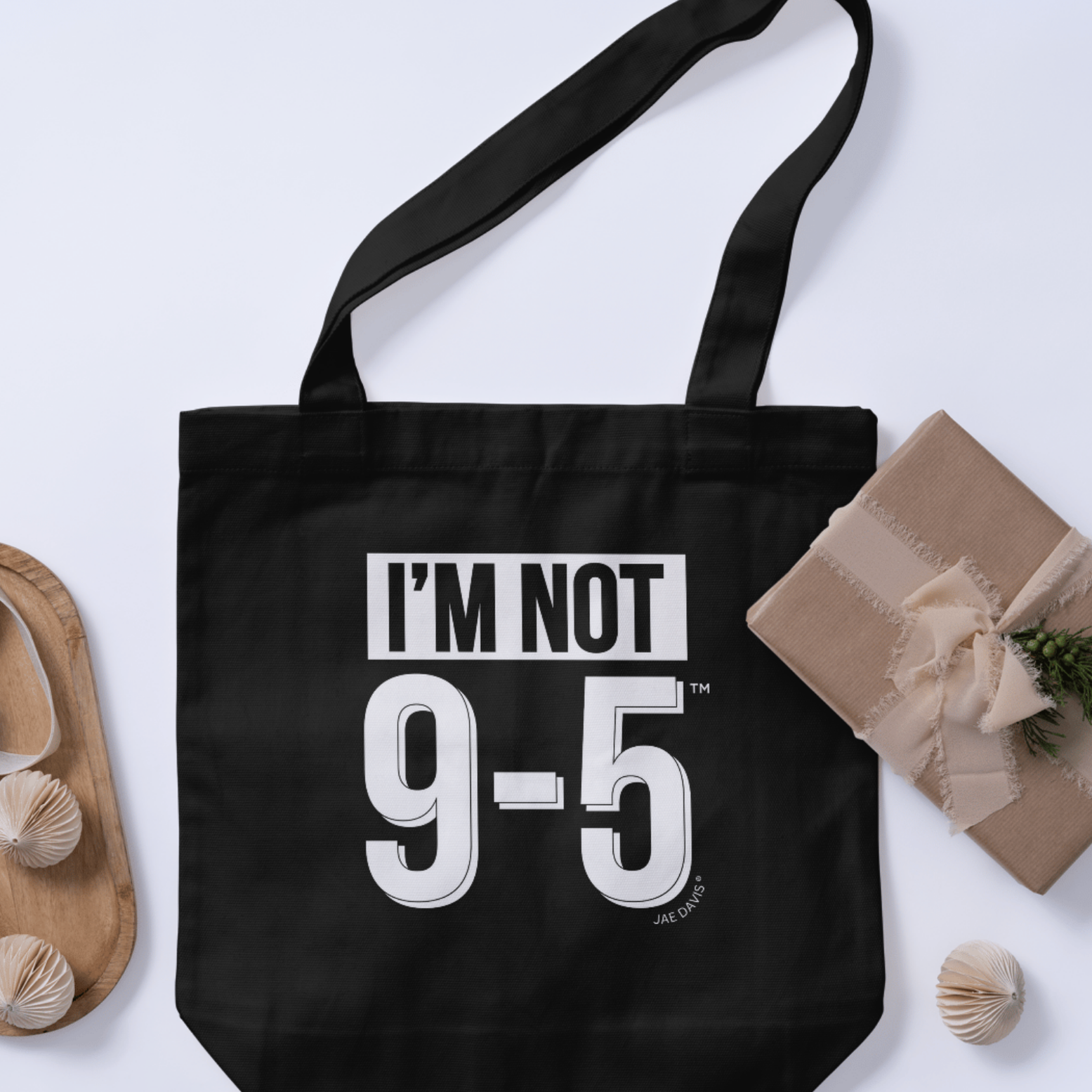 Black tote bag with 'I'm Not 9-5' text on a light gray background