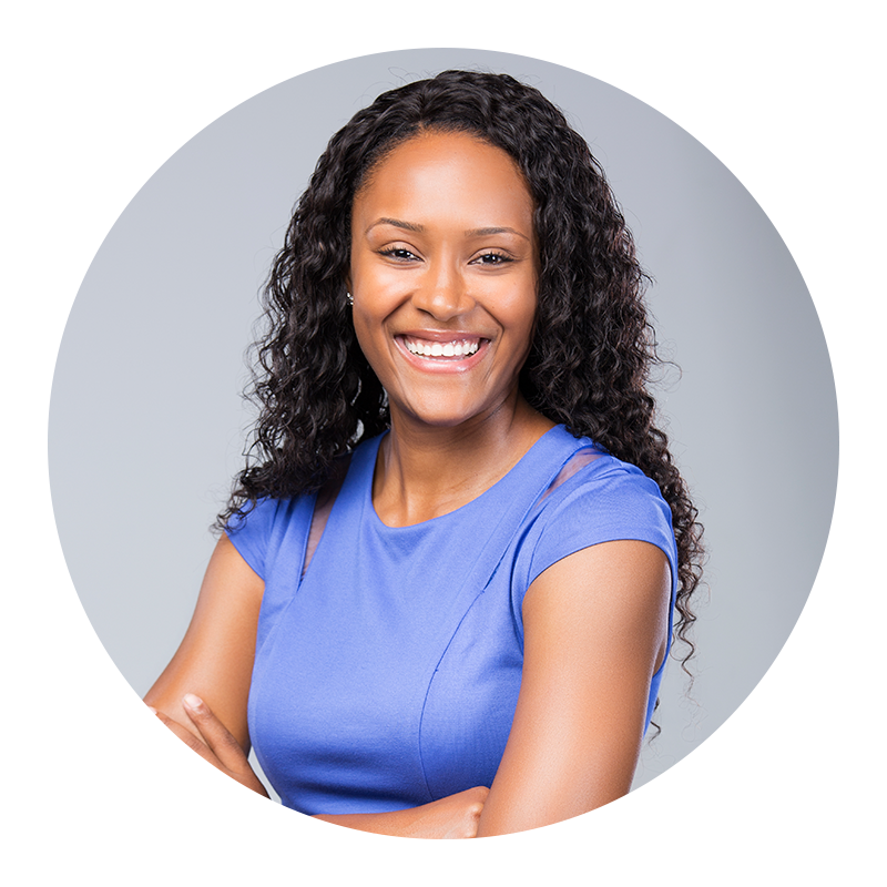 Woman with curly hair wearing a blue top on a gray background